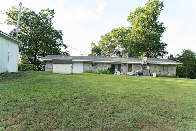 rear view of property featuring a yard