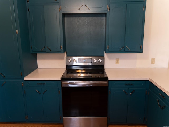 kitchen featuring blue cabinets and stainless steel electric stove