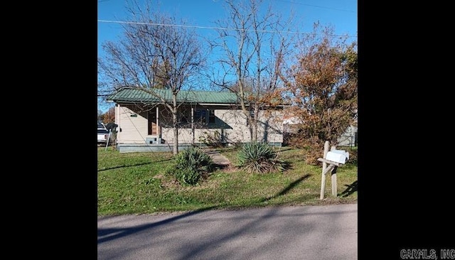 view of side of property with a lawn