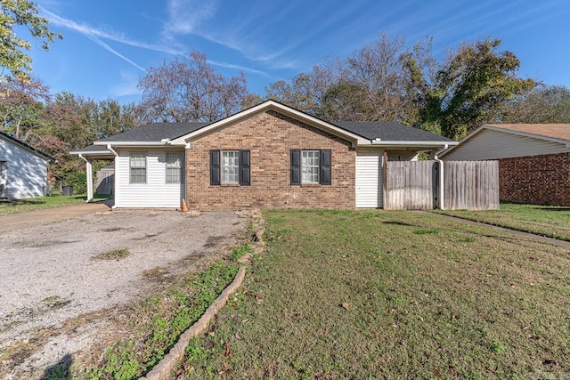 ranch-style house with a front yard and a carport