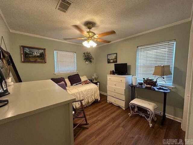 bedroom with dark hardwood / wood-style floors, ceiling fan, crown molding, and a textured ceiling