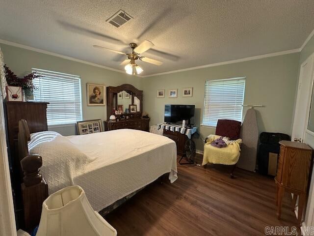 bedroom with ceiling fan, dark hardwood / wood-style flooring, a textured ceiling, and ornamental molding