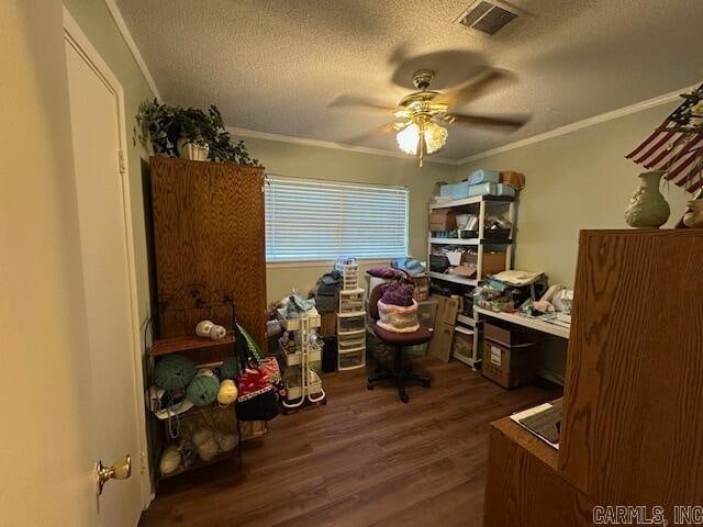 office with a textured ceiling, ceiling fan, ornamental molding, and dark wood-type flooring