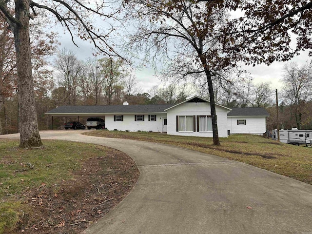 single story home featuring a front yard and a carport