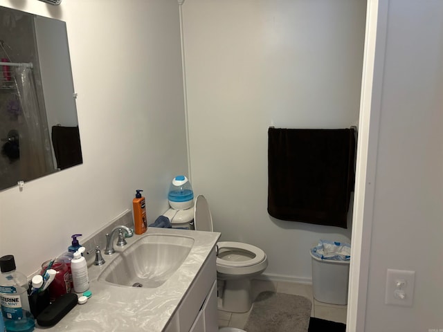 bathroom featuring tile patterned flooring, vanity, and toilet