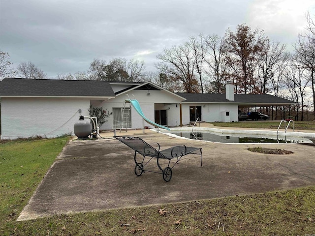 rear view of house with a lawn