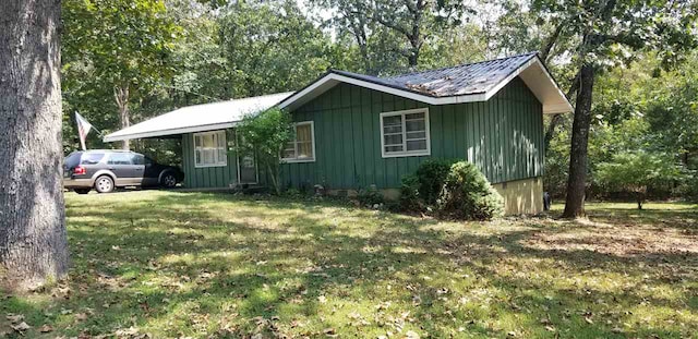 view of side of home featuring a yard