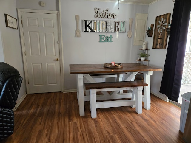 dining room featuring dark hardwood / wood-style floors and ornamental molding