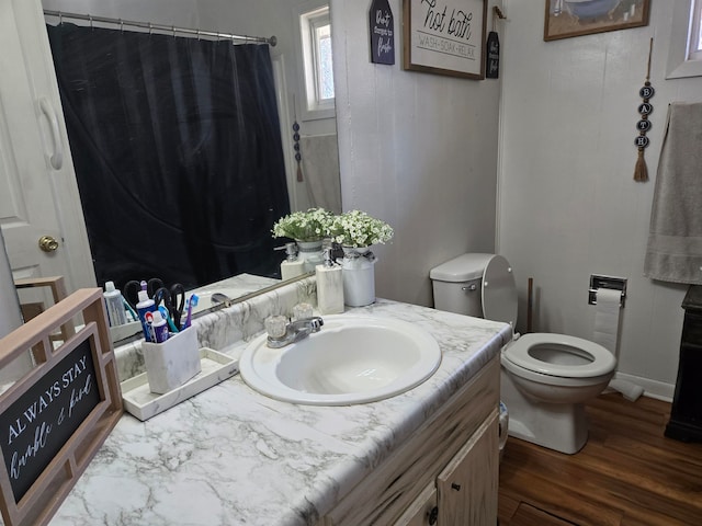 bathroom with a shower with curtain, vanity, hardwood / wood-style flooring, and toilet