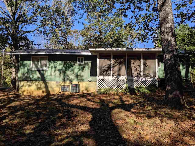 view of front of house featuring central AC and a sunroom