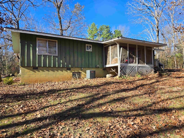 ranch-style home with a sunroom and central AC unit