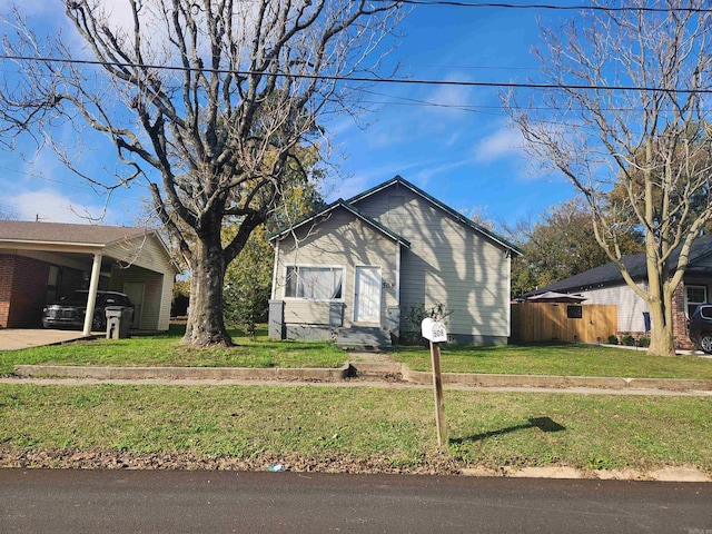 view of property exterior featuring a yard and a carport