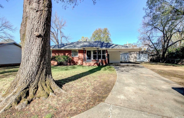 single story home with a front yard and a carport