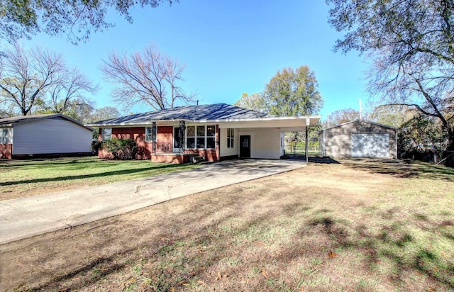 ranch-style home with an outbuilding, a front lawn, a garage, and a carport