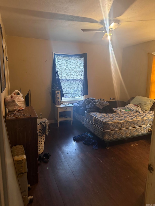 bedroom featuring ceiling fan and dark hardwood / wood-style flooring