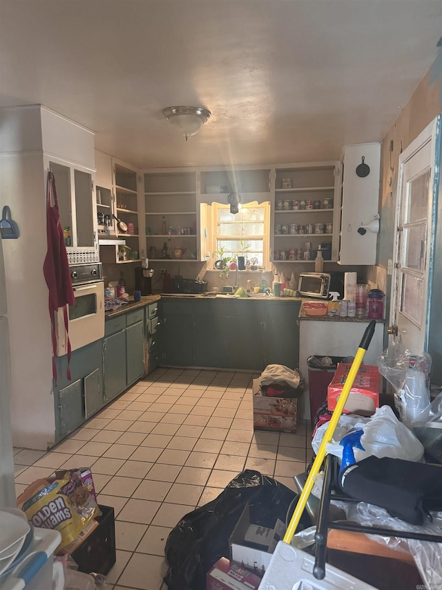 kitchen with oven and light tile patterned floors