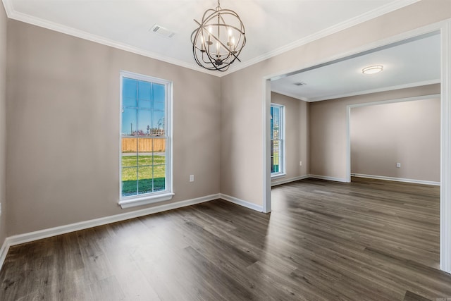 empty room featuring dark hardwood / wood-style floors, crown molding, and a chandelier