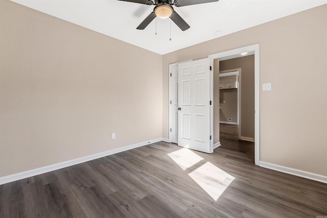 unfurnished bedroom featuring ceiling fan and dark wood-type flooring