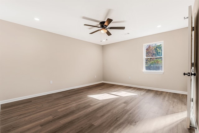 unfurnished room with ceiling fan and dark hardwood / wood-style flooring