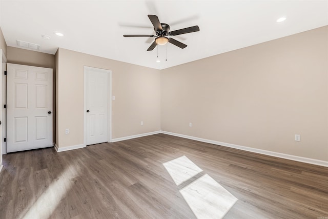 unfurnished bedroom with ceiling fan and wood-type flooring