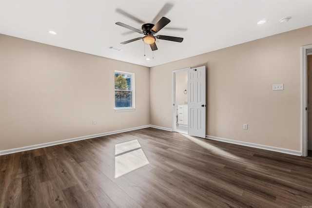 spare room with ceiling fan and dark wood-type flooring