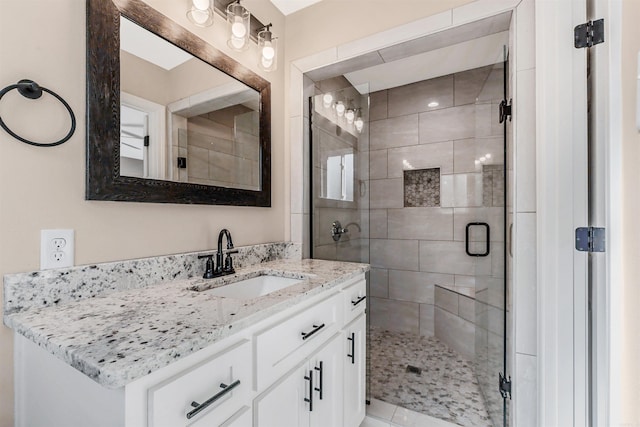 bathroom with vanity and a shower with shower door