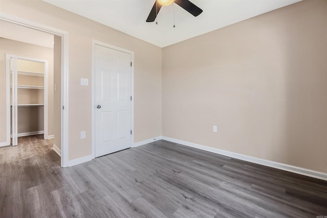 unfurnished bedroom featuring ceiling fan, a closet, and dark hardwood / wood-style floors