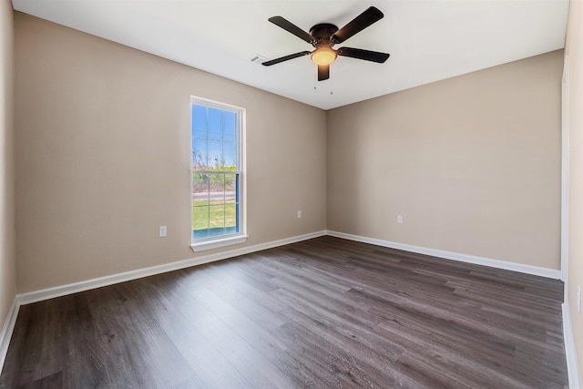 spare room featuring dark hardwood / wood-style floors and ceiling fan