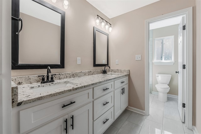 bathroom with tile patterned flooring, vanity, and toilet