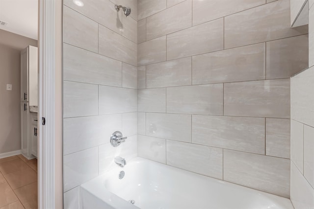 bathroom with tile patterned flooring and tiled shower / bath combo