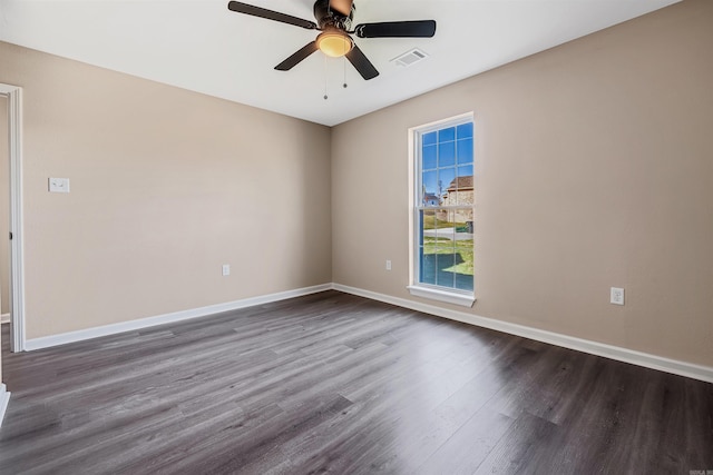 spare room featuring ceiling fan and dark wood-type flooring