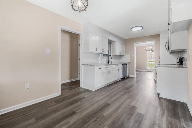 kitchen with tasteful backsplash, sink, dishwasher, white cabinets, and dark hardwood / wood-style floors