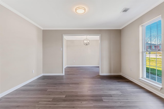 spare room featuring dark hardwood / wood-style flooring, crown molding, and a wealth of natural light