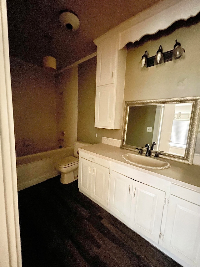 full bathroom featuring bathtub / shower combination, vanity, hardwood / wood-style flooring, and toilet