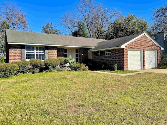 ranch-style house featuring a garage and a front lawn