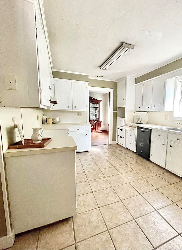 kitchen featuring white cabinetry, black dishwasher, and light tile patterned floors