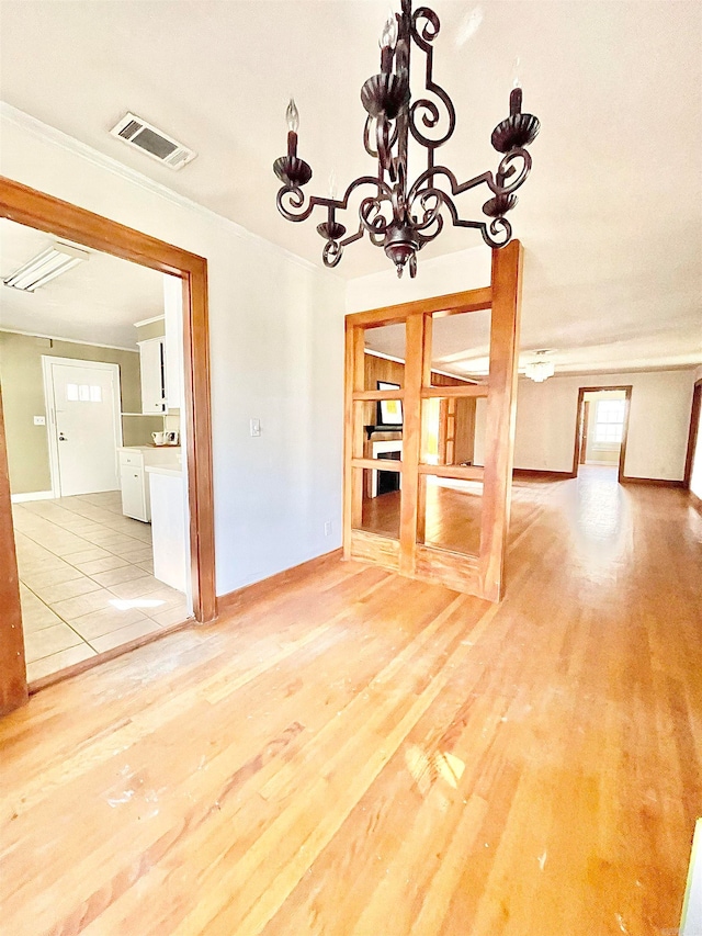 unfurnished dining area with light hardwood / wood-style flooring and a chandelier