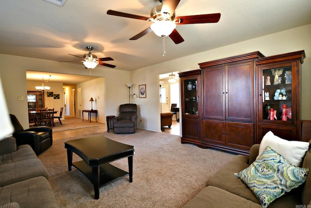 carpeted living room featuring an inviting chandelier