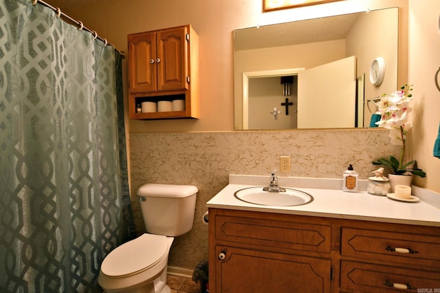 bathroom featuring vanity, toilet, and a textured ceiling