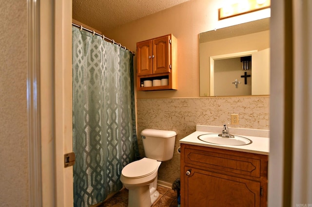 bathroom featuring vanity, tile patterned floors, toilet, a textured ceiling, and tile walls