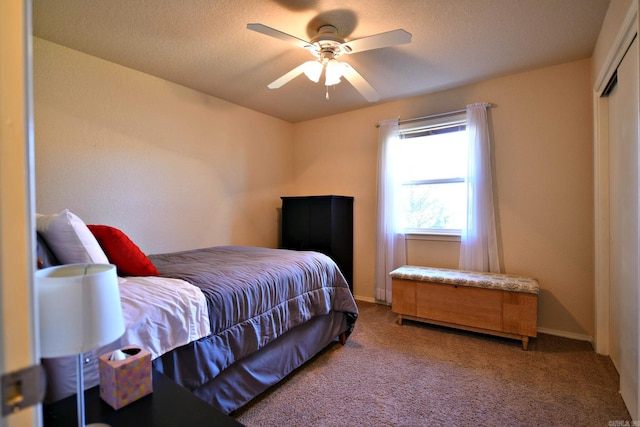 bedroom featuring carpet flooring, a textured ceiling, a closet, and ceiling fan