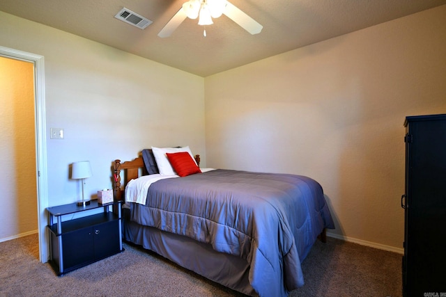 bedroom with dark colored carpet and ceiling fan