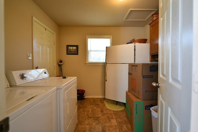 washroom featuring a textured ceiling and washing machine and clothes dryer