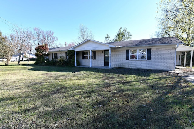 ranch-style home featuring a front lawn and a carport