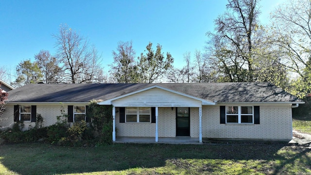 ranch-style house with a porch and a front yard