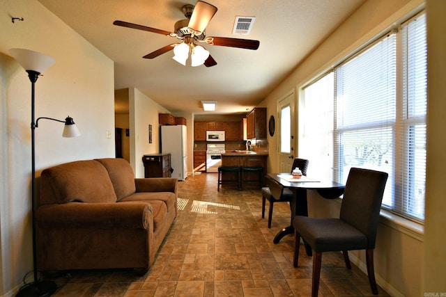 living room featuring ceiling fan and sink