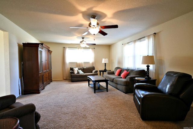 living room featuring a textured ceiling, light colored carpet, plenty of natural light, and ceiling fan