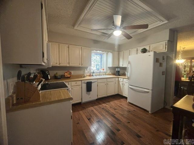 kitchen with a textured ceiling, white cabinetry, white appliances, and dark wood-type flooring