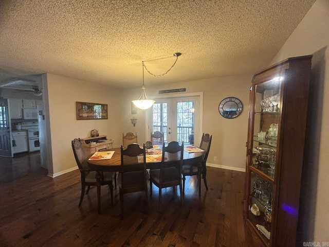 dining room featuring ceiling fan, french doors, dark wood-type flooring, and a textured ceiling