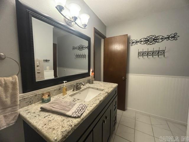 bathroom with vanity and a notable chandelier